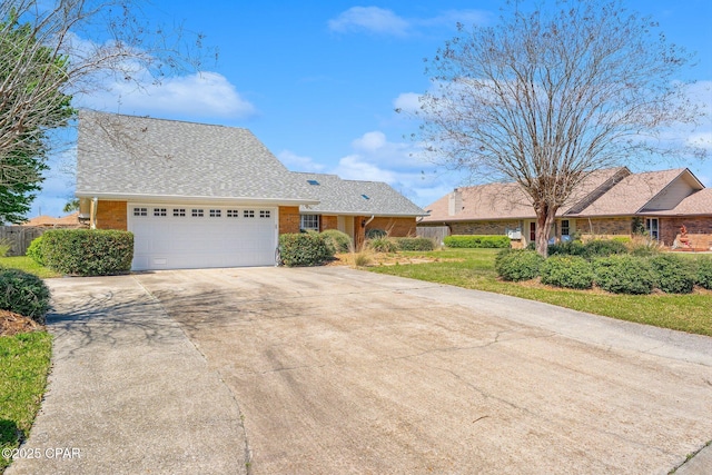 ranch-style house with a garage, brick siding, concrete driveway, and a front lawn