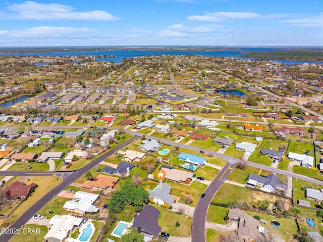 birds eye view of property with a residential view and a water view