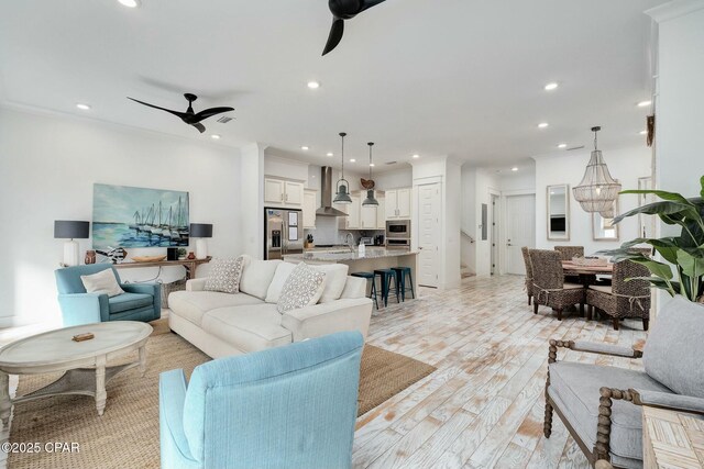 living area featuring ceiling fan, recessed lighting, and light wood-style floors