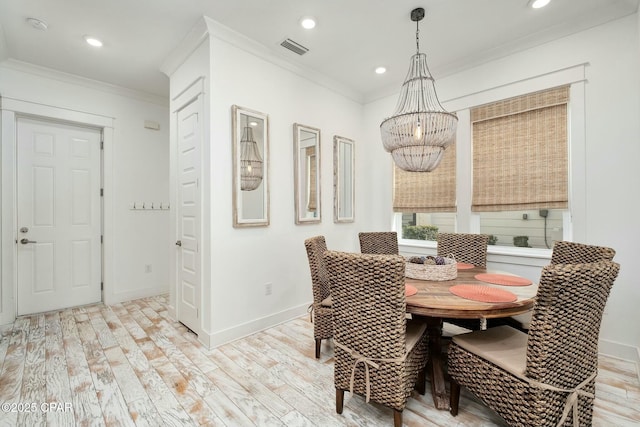 dining room featuring light wood-style flooring, visible vents, ornamental molding, and baseboards