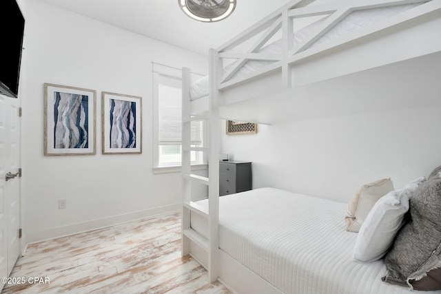 bedroom featuring baseboards and light wood-style floors