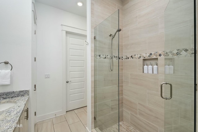 bathroom featuring vanity and a shower stall