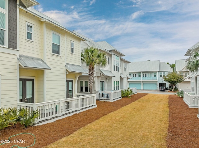 rear view of property featuring a residential view and metal roof