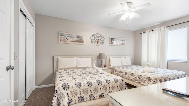 bedroom with a closet, baseboards, carpet, and a ceiling fan