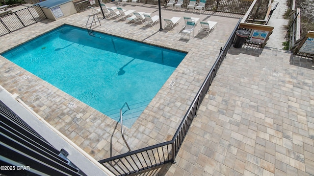 pool featuring a patio area and fence