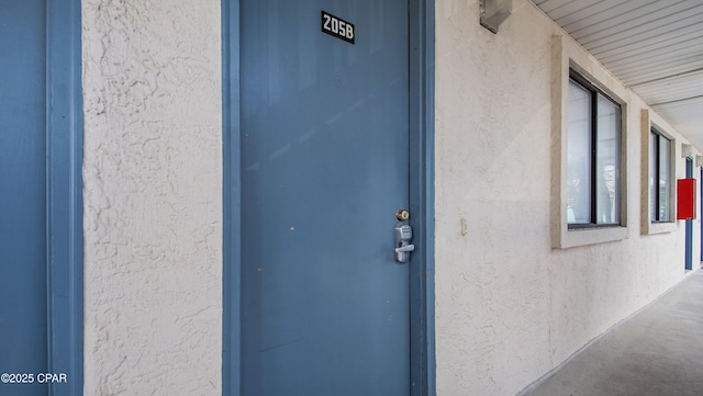 view of exterior entry featuring stucco siding