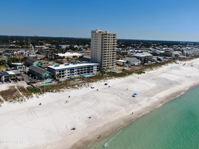 drone / aerial view featuring a water view and a beach view