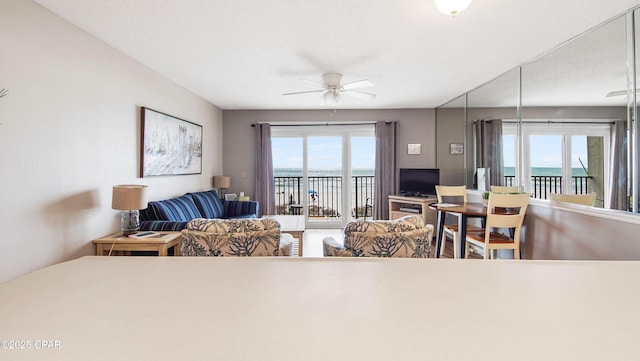 living area with a ceiling fan