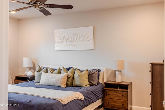 bedroom with a ceiling fan and baseboards