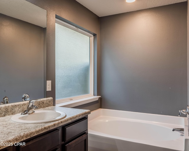 bathroom with a bath and vanity