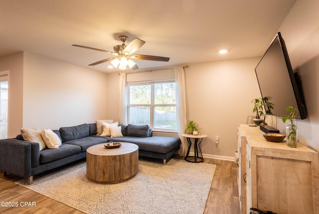 living room with recessed lighting, baseboards, light wood-style floors, and ceiling fan