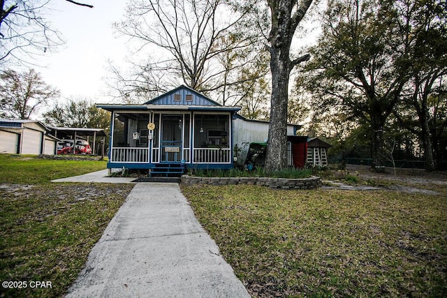 bungalow-style home featuring a front yard and a sunroom