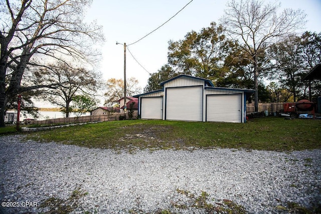 detached garage featuring fence