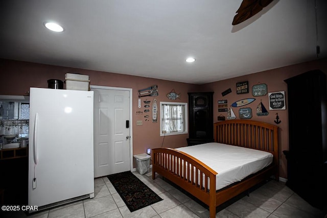 bedroom with light tile patterned flooring, recessed lighting, and freestanding refrigerator