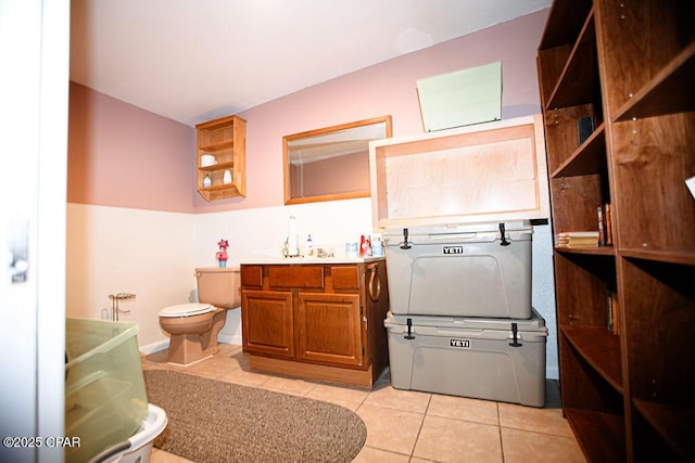 bathroom featuring tile patterned flooring, toilet, and vanity