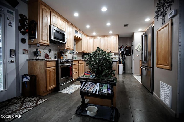 kitchen with tasteful backsplash, visible vents, dark countertops, recessed lighting, and stainless steel appliances