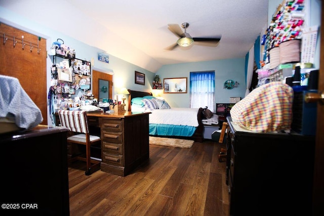 bedroom featuring vaulted ceiling, dark wood-style floors, and ceiling fan