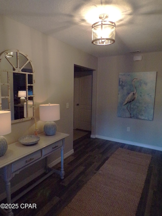 dining room featuring a notable chandelier, wood finished floors, and baseboards