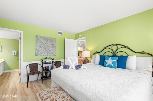 bedroom with visible vents and light wood-type flooring