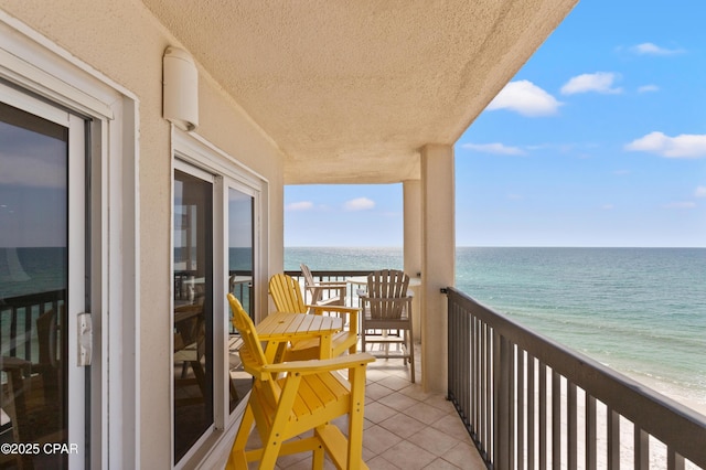 balcony with a view of the beach and a water view