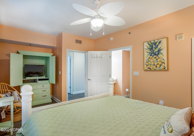 bedroom with visible vents, baseboards, and a ceiling fan