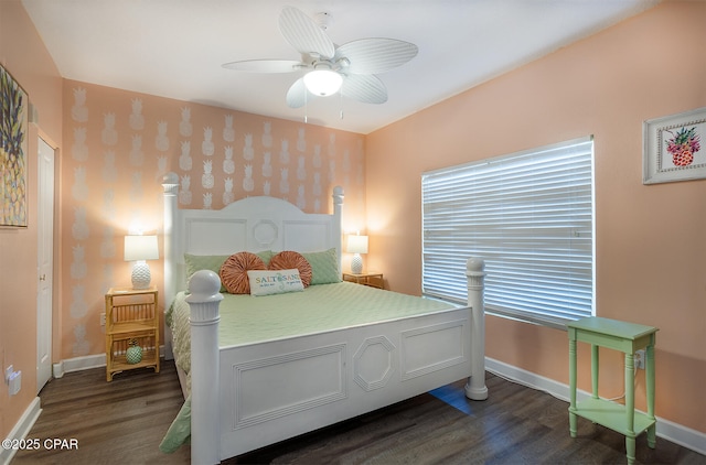 bedroom featuring baseboards, a ceiling fan, and dark wood-style flooring