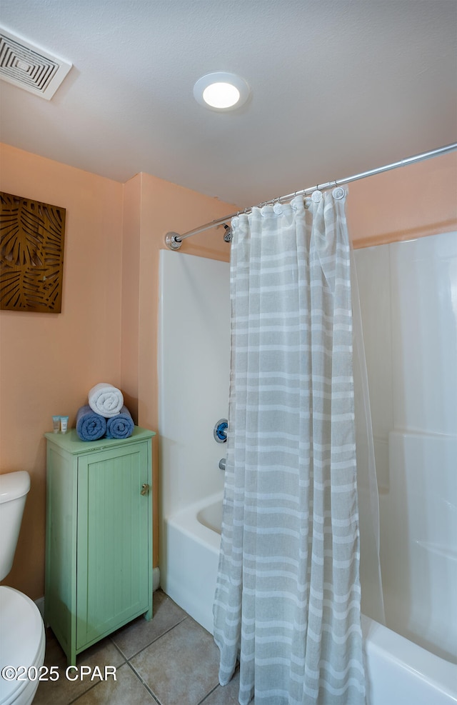 bathroom with tile patterned floors, toilet, shower / bath combo, and visible vents