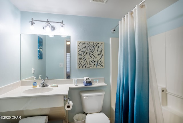 bathroom with visible vents, toilet, and vanity