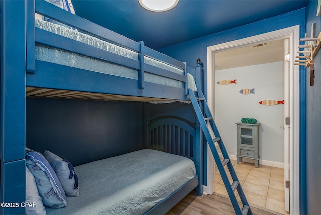 tiled bedroom featuring visible vents and baseboards