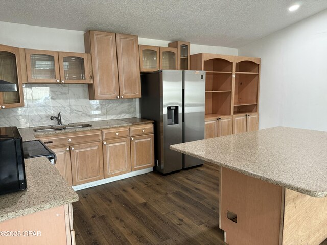 816 N E, Panama City, FL 32401 - kitchen featuring backsplash, dark wood-type flooring, stainless steel fridge, a textured ceiling, and a sink