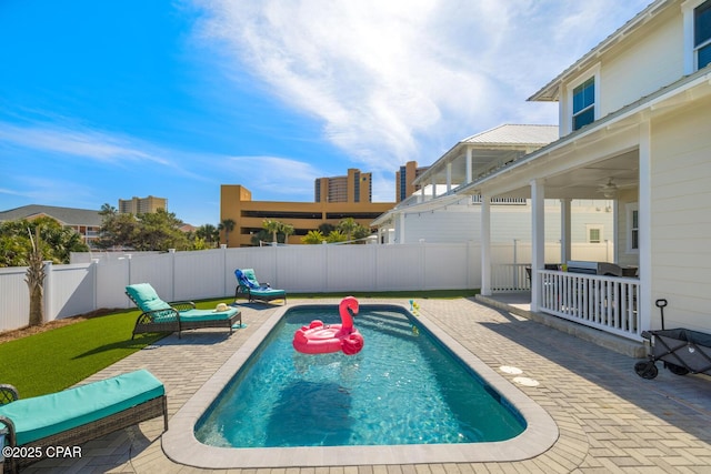 view of swimming pool with a fenced backyard, a fenced in pool, a patio, and ceiling fan