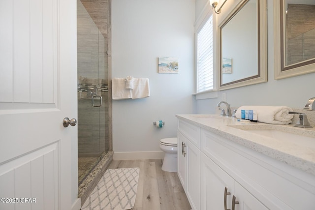 227 Sands St, Panama City Beach, FL 32413 - full bathroom with double vanity, wood finished floors, and a shower stall