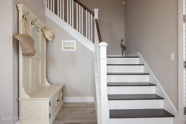 stairway with baseboards and wood finished floors