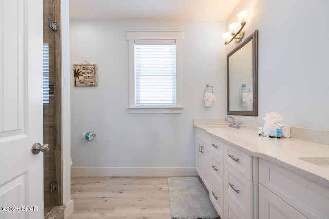 227 Sands St, Panama City Beach, FL 32413 - bathroom featuring double vanity, wood finished floors, and a shower