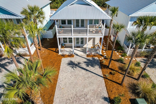 227 Sands St, Panama City Beach, FL 32413 - view of front of house with french doors, covered porch, and a fenced backyard