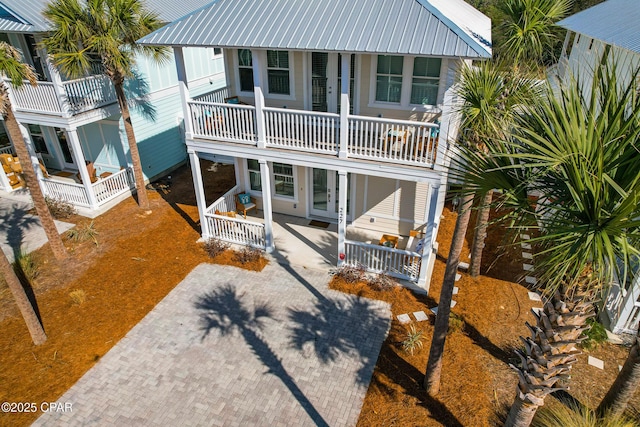 back of property with a porch and metal roof