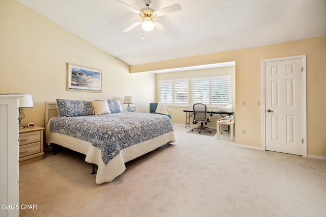 bedroom with baseboards, lofted ceiling, light colored carpet, and ceiling fan