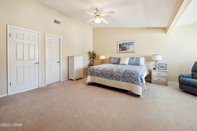 carpeted bedroom with visible vents, lofted ceiling, baseboards, and ceiling fan