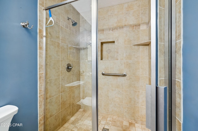 full bath featuring a shower stall and toilet