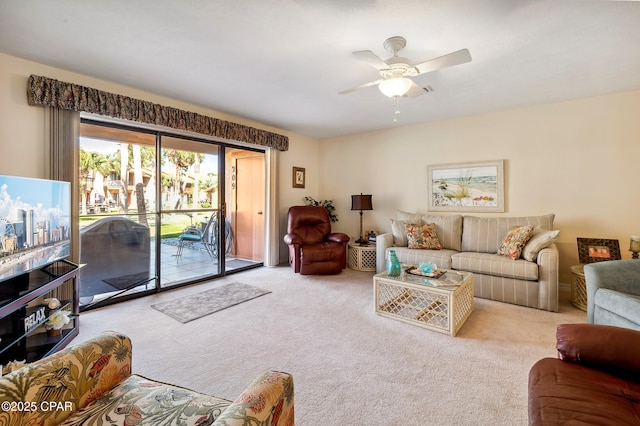 carpeted living area with a ceiling fan