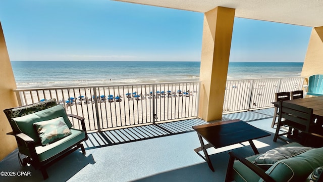 balcony with a view of the beach and a water view