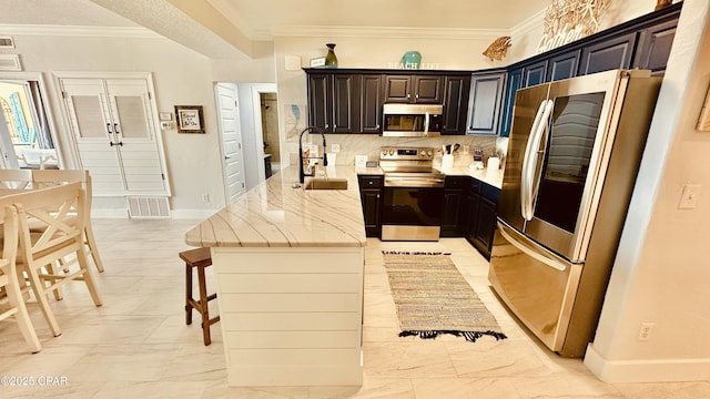 kitchen with light stone counters, visible vents, a sink, stainless steel appliances, and crown molding