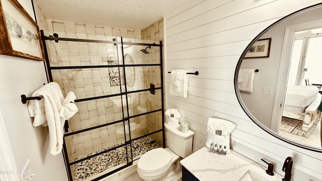 full bathroom featuring a textured ceiling, a stall shower, wood walls, and toilet