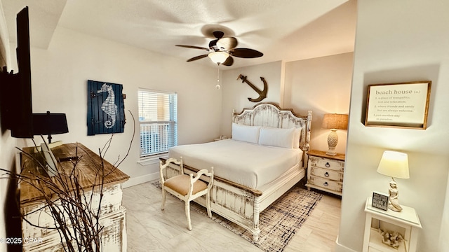 bedroom with baseboards and a ceiling fan