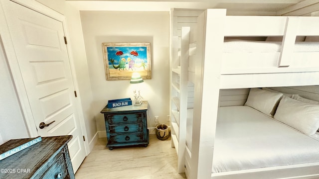 bedroom with baseboards and marble finish floor