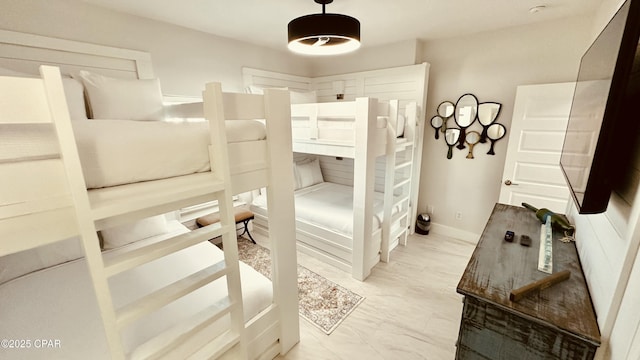 bedroom featuring baseboards and marble finish floor