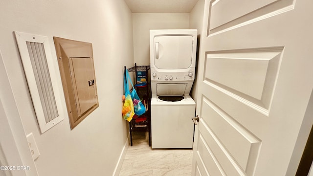 washroom featuring baseboards, stacked washer and dryer, electric panel, laundry area, and marble finish floor