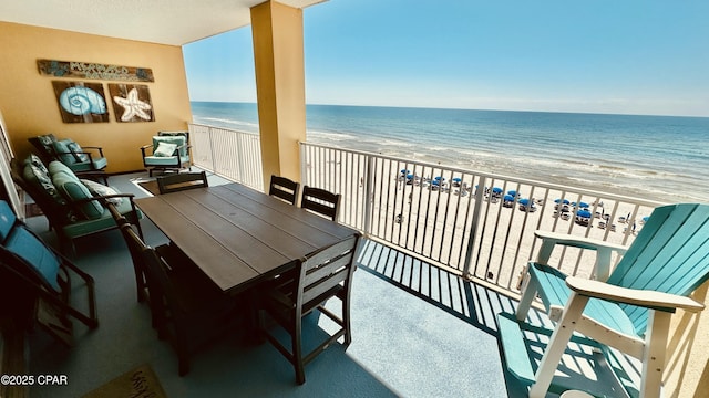 balcony with a water view and a beach view