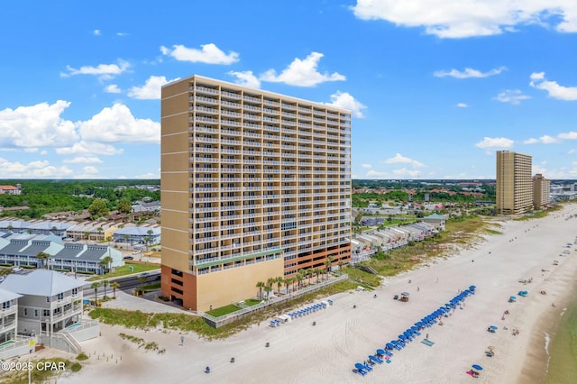 view of building exterior with a city view and a view of the beach