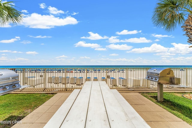 exterior space with area for grilling and a water view